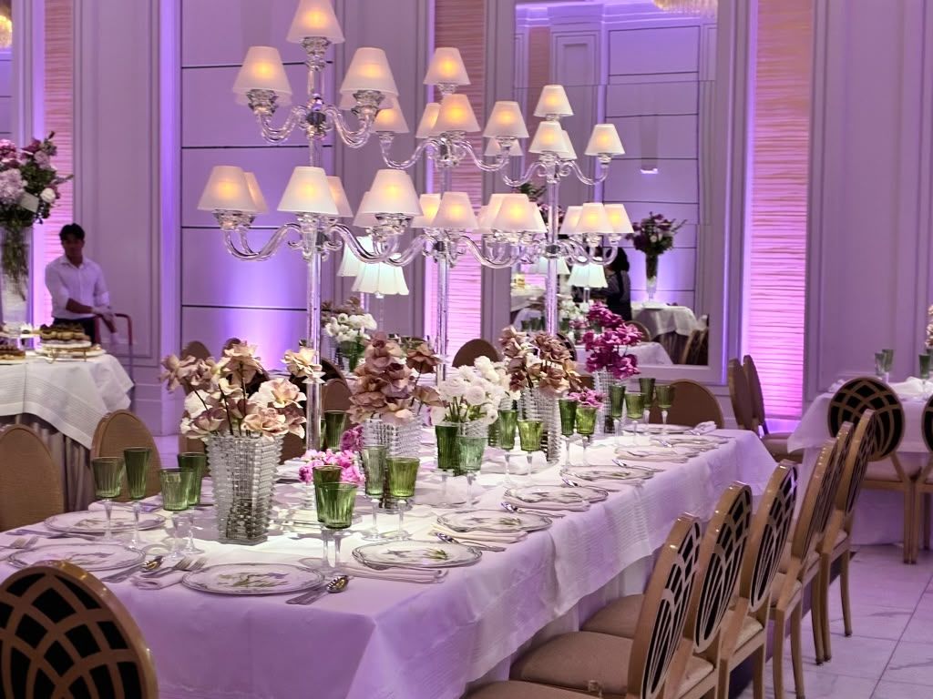 Ballroom washed in purple uplighting with set tables
